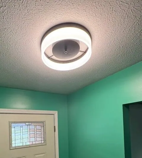 Entryway after — new flush-mount LED fixture installed